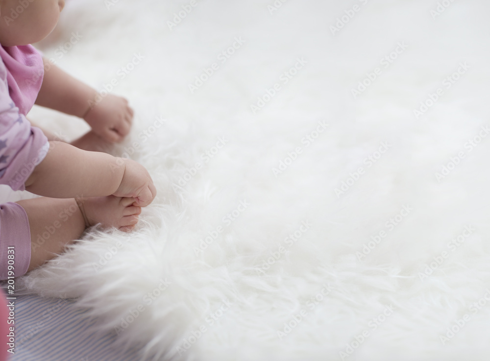 baby feet on white blanket. copy space. selective focus baby feet on white blanket. copy space. selective focus