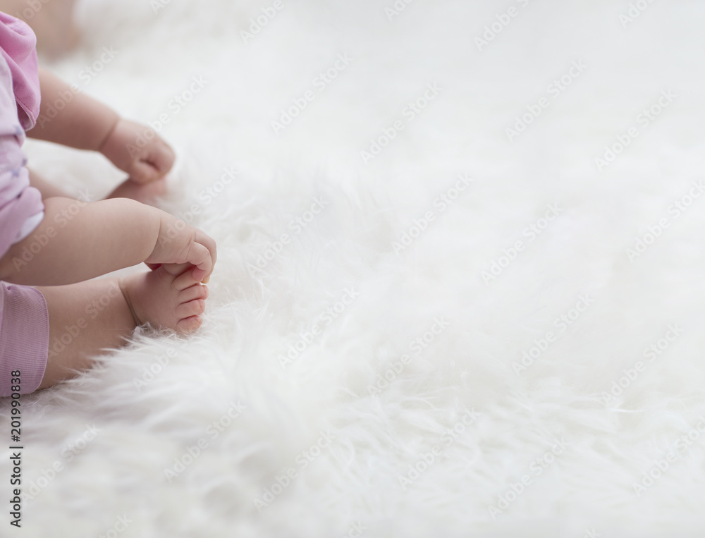 baby feet on white blanket. copy space. selective focus baby feet on white blanket. copy space. selective focus