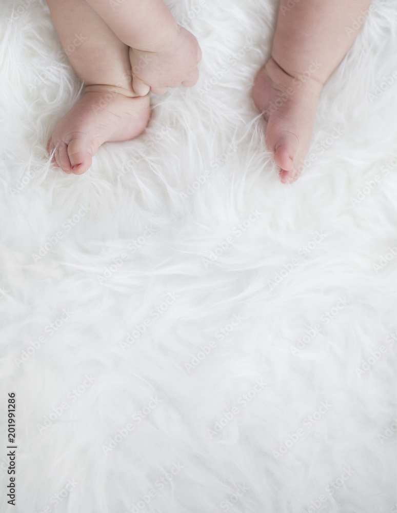 baby feet on white blanket. copy space. selective focus baby feet on white blanket. copy space. selective focus