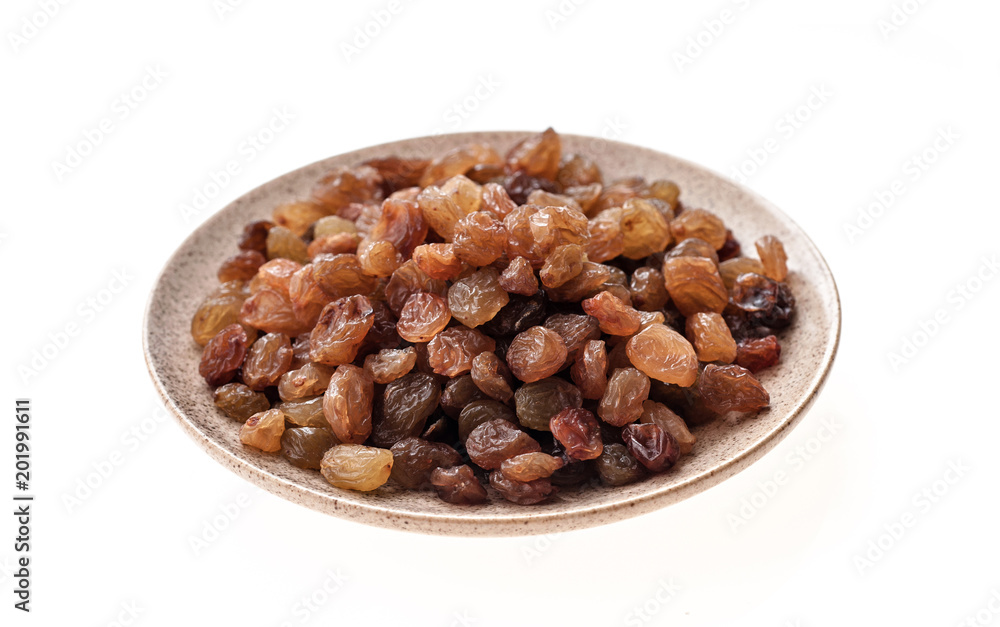 Raisin in plate on white background isolation, close-up Raisin in plate on white background isolation, close-up