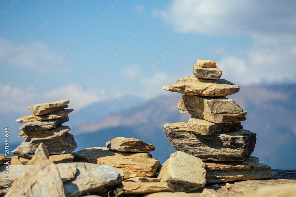 Pyramids of stones against the background of mountains. the concept of balance and tranquility.Yoga in the nature in the mountains Pyramids of stones against the background of mountains. the concept of balance and tranquility.Yoga in the nature in the mountains