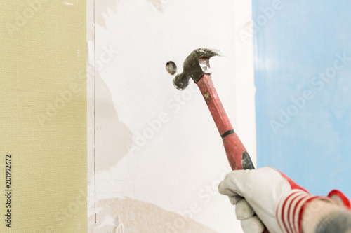 Fotografia, Obraz Builder hitting a wall with a hammer