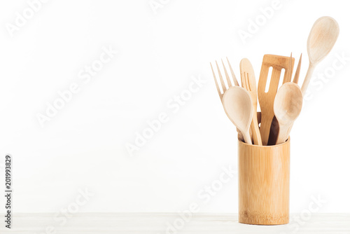 closeup view of wooden kitchen utensils isolated on white background