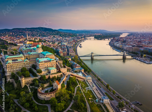 Budapest, Hungary - Aerial skyline view of Buda Castle Royal Palace and South Rondella with Castle District and Szechenyi Chain Bridge at sunrise