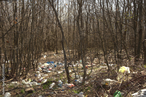 Garbage at forest, landfill inside trees,mountains