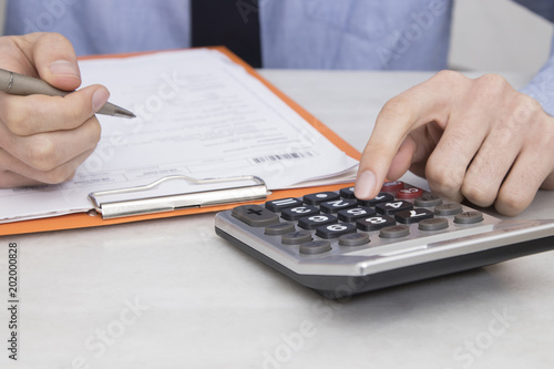 closeup of hands with calculator on the office desk