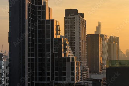urban cityscape on sunrise light pass through the building