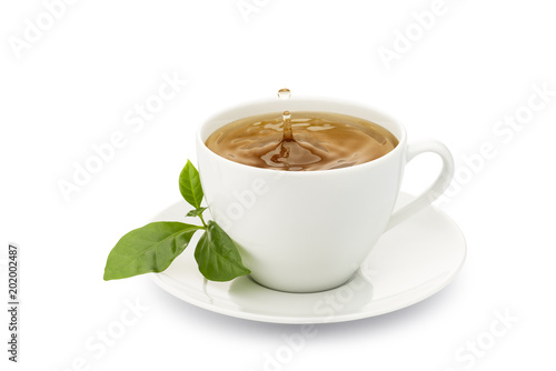 cup of tea with leaves and drop splashing, on white background