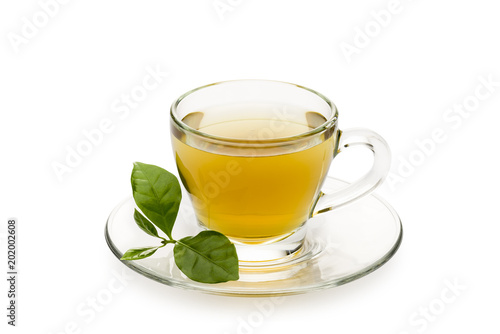 tea in glass cup with leaves, on white background