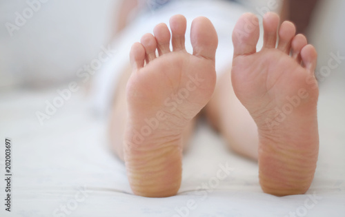 Feet of women sleeping on bed. © nunawwoofy