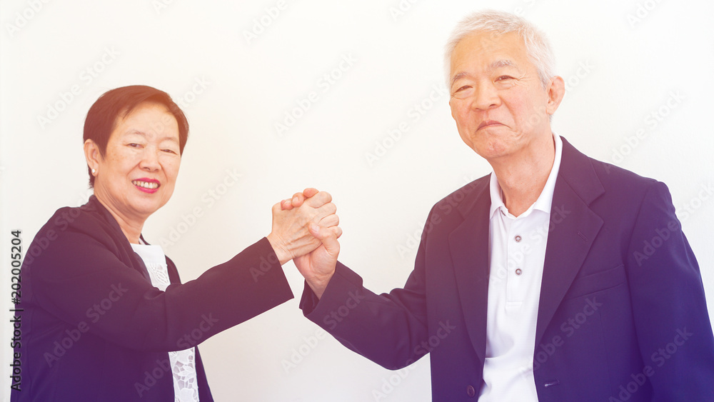 Asian senior business people couple holding hand for successful life Asian senior business people couple holding hand for successful life