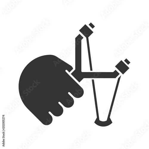 Hand holding slingshot glyph icon