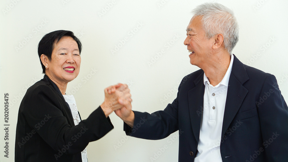 Asian senior business people couple holding hand for successful life Asian senior business people couple holding hand for successful life