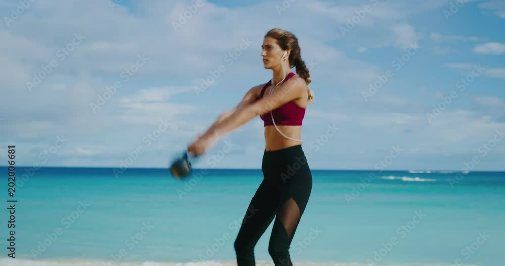 Athletic woman working out with kettlebells Athletic woman working out with kettlebells