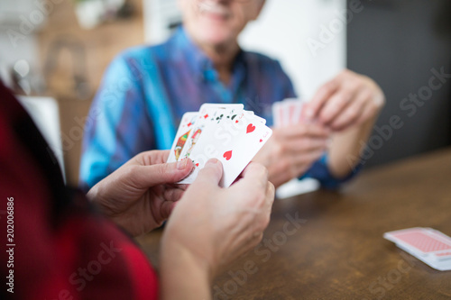 Senior lady playing cards with her husband