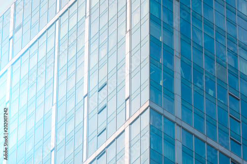 Angle glass facades of a window of financial skyscrapers, a corner of a building close-up.