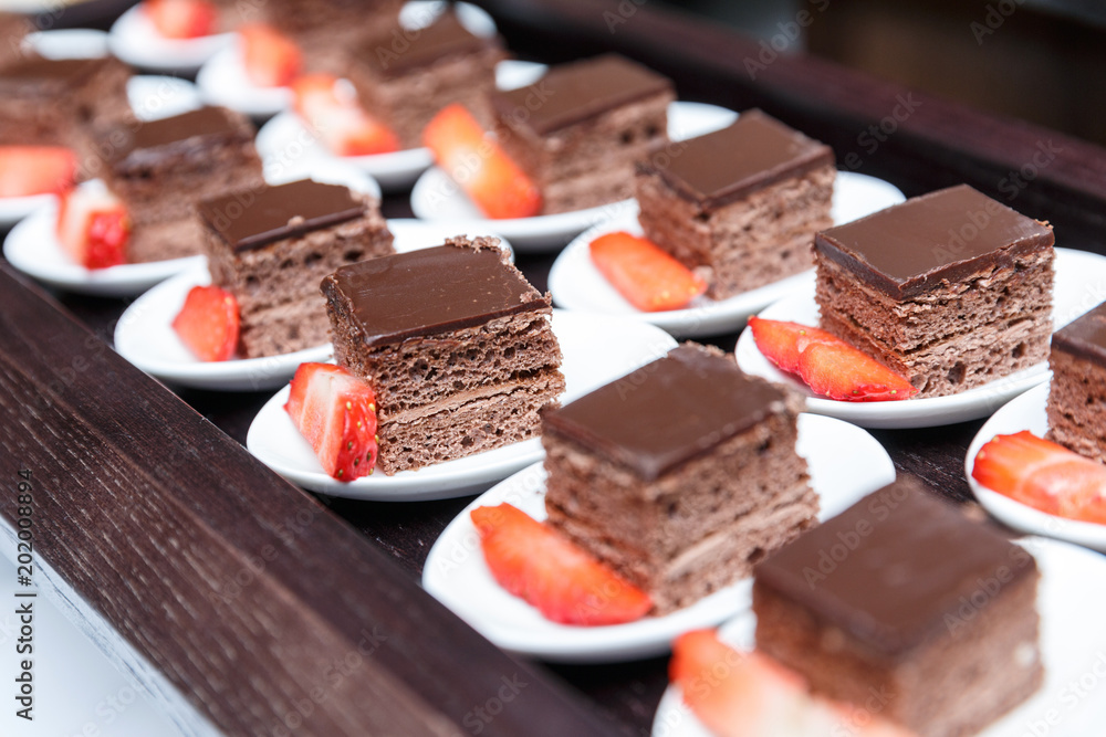 Set of small delicious chocolate cakes served in a buffet for celebration