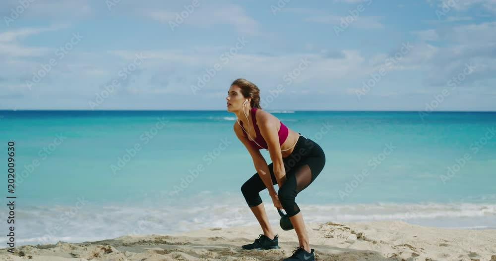 Athletic woman working out with kettlebells Athletic woman working out with kettlebells