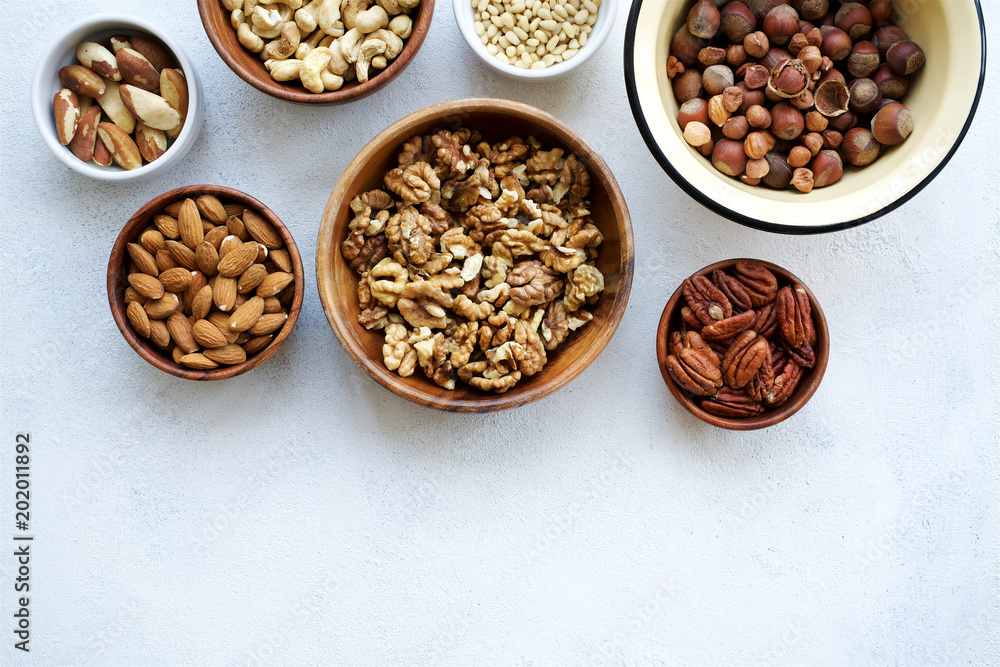 Variety of nuts on light concrete background Top view and empty space
Variety of nuts on light concrete background Top view and empty space