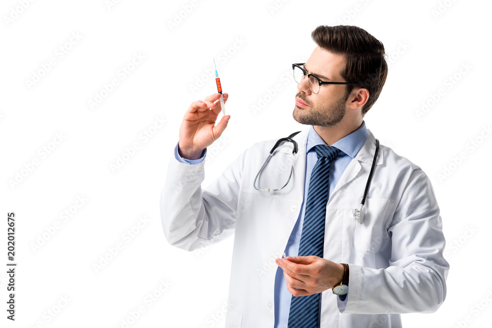 Medical worker wearing white coat with stethoscope and looking at syringe isolated on white Medical worker wearing white coat with stethoscope and looking at syringe isolated on white