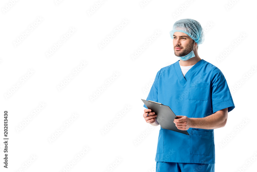 Surgeon wearing blue uniform and writing diagnosis in clipboard isolated on white Surgeon wearing blue uniform and writing diagnosis in clipboard isolated on white