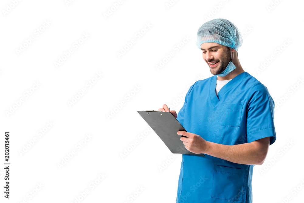 Cheerful surgeon wearing blue uniform and holding clipboard isolated on white Cheerful surgeon wearing blue uniform and holding clipboard isolated on white