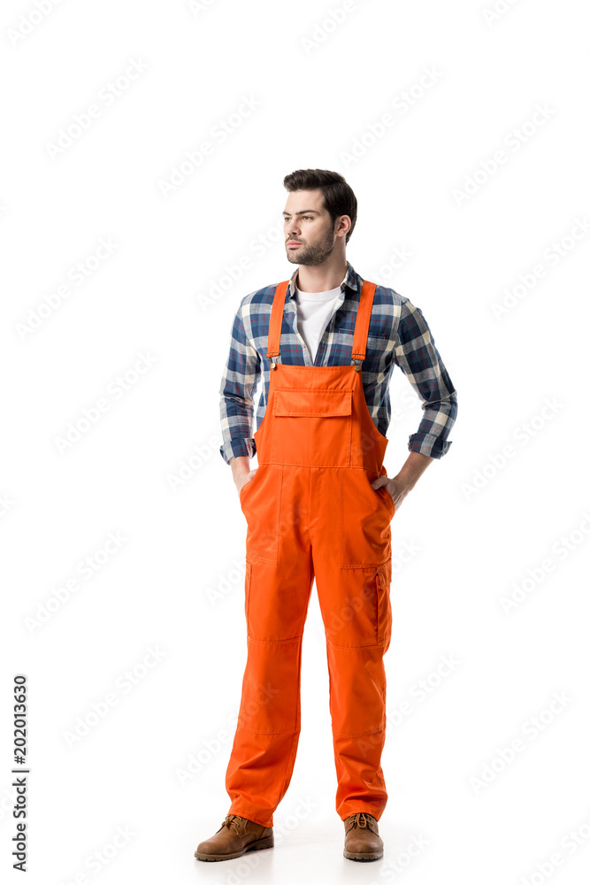 Young confident repairman in orange overall isolated on white Young confident repairman in orange overall isolated on white