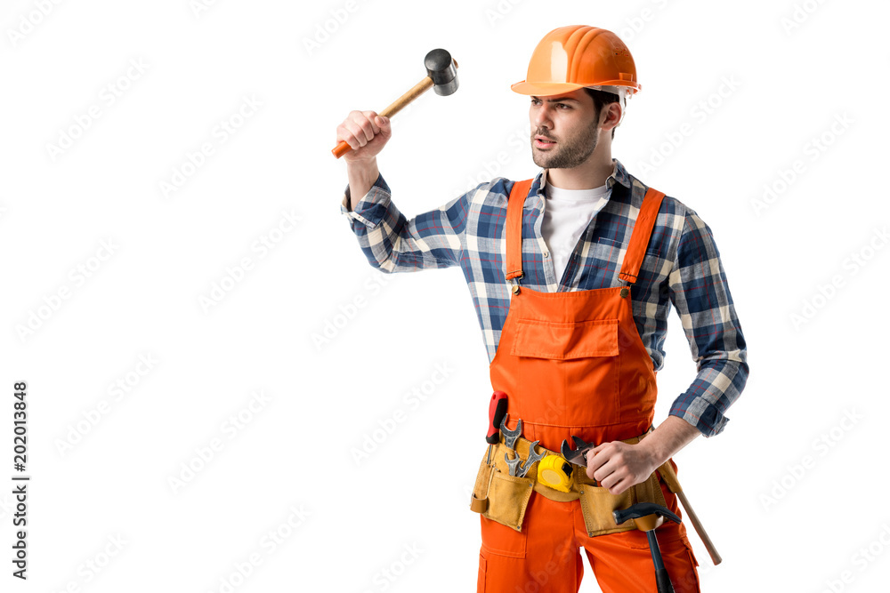 Bearded workman in orange overall and hardhat using hammer isolated on white Bearded workman in orange overall and hardhat using hammer isolated on white