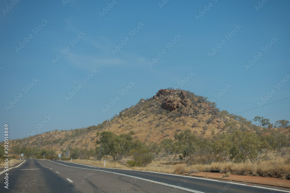 Small hill with rough rocks in the outback of Queensland in Australia