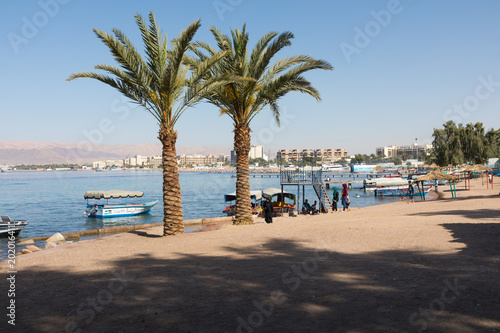 Touristic ships on the beach of Aqaba, Jordan. Popular resort, located at the north of the Red Sea. © Curioso.Photography
