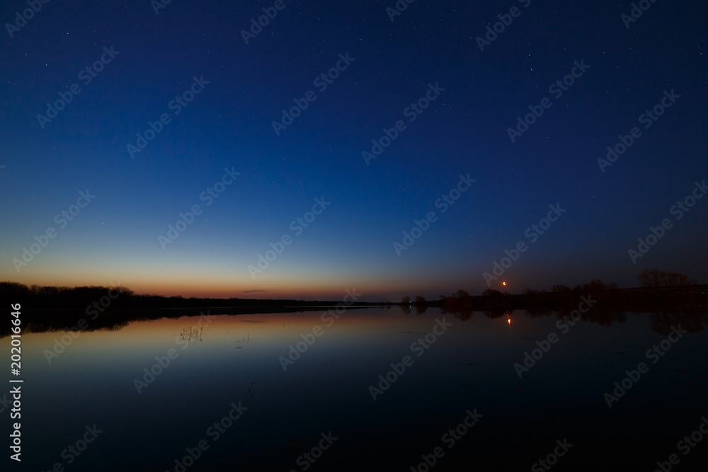 Sky with the stars before dawn. Night landscape with a lake. Sky with the stars before dawn. Night landscape with a lake.
