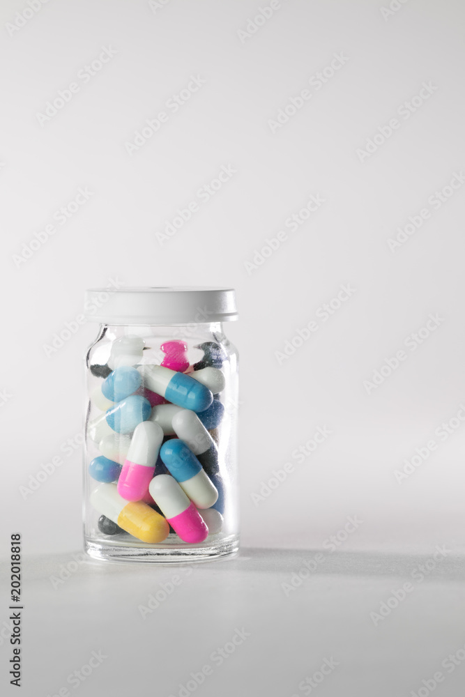 Bunch of colorful pills in glass jar Bunch of colorful pills in glass jar