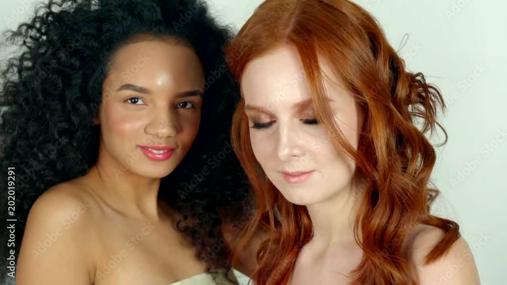 portrait of two adorable teenagers, women have stylish hairstyles and a natural make-up on their faces, models are posing in the studio and having fun portrait of two adorable teenagers, women have stylish hairstyles and a natural make-up on their faces, models are posing in the studio and having fun