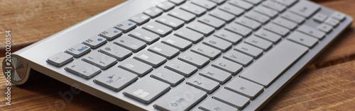 Computer keyboard and on the desk close up.