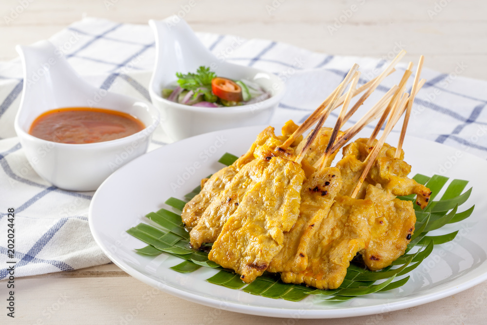 Grilled pork served with peanut sauce or sweet and sour sauce, Thai food Grilled pork served with peanut sauce or sweet and sour sauce, Thai food