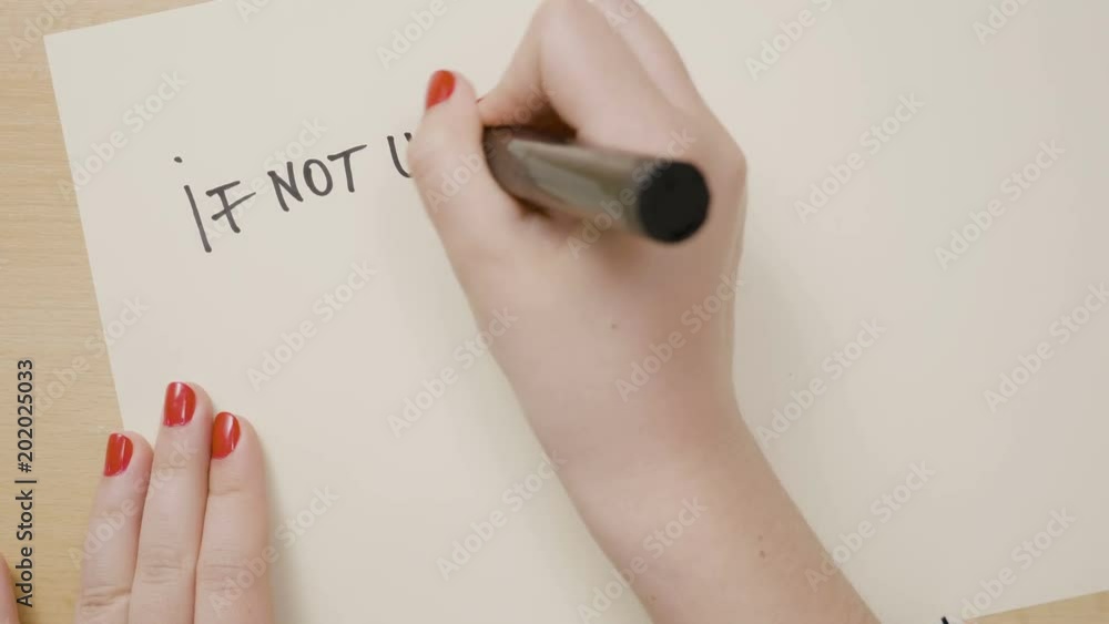 Woman hands writing if not us who and if not now when question marks motivational quote on a white paper with a black marker Woman hands writing if not us who and if not now when question marks motivational quote on a white paper with a black marker