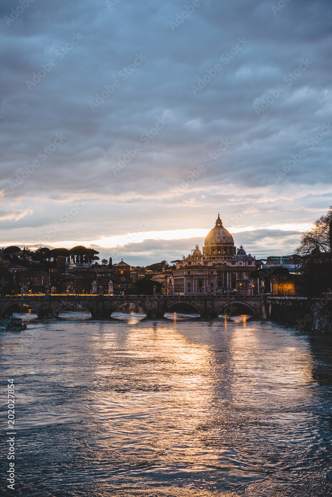 st peters basilica and tiber river during sunrise in Rome, Italy