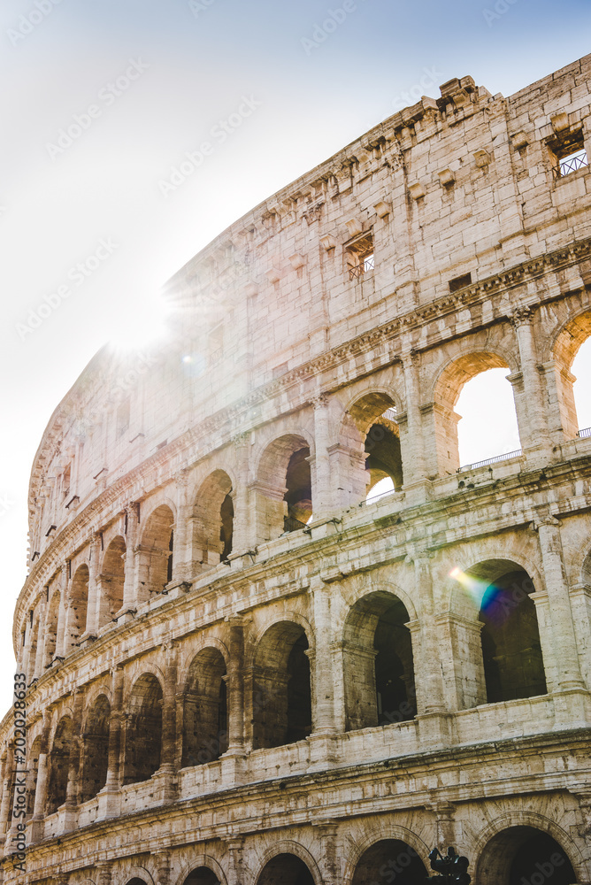 ancient beautiful Colosseum ruins with sunshine in Rome, Italy