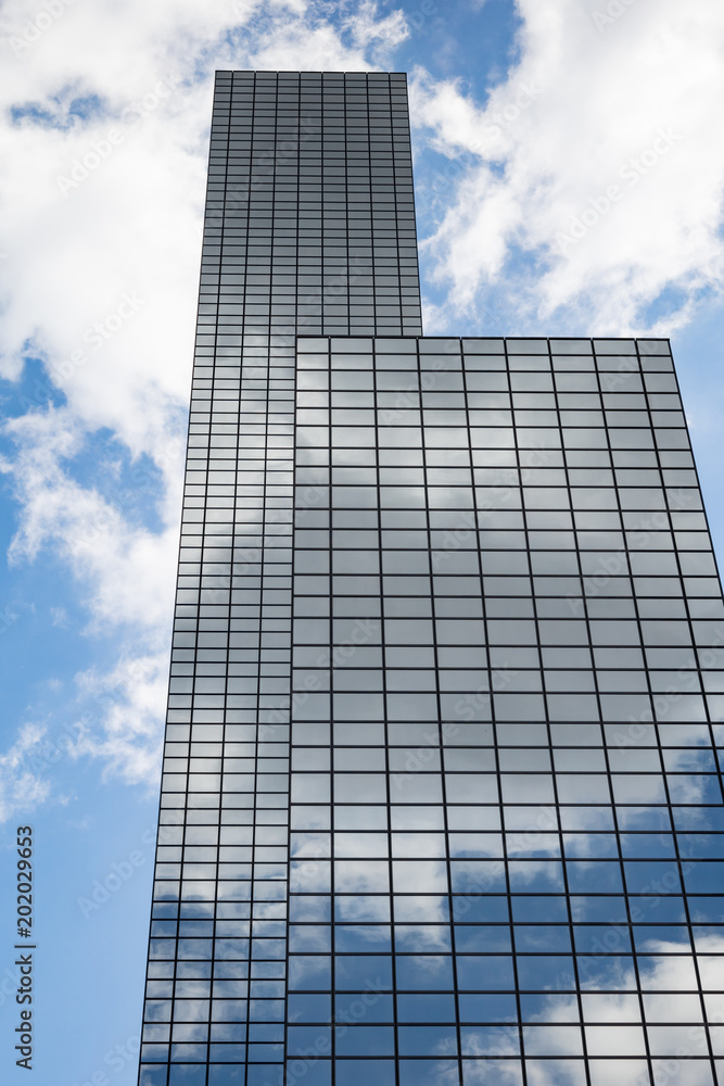 Glass office building and cloudy sky Glass office building and cloudy sky
