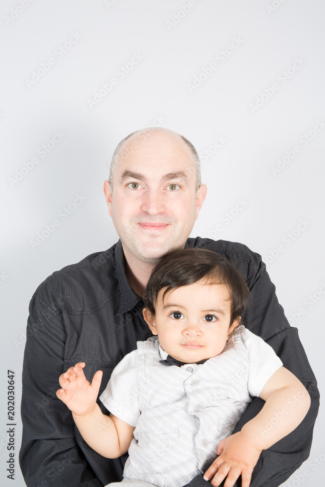 Handsome bald man with his son on white background a single divorce parent father Handsome bald man with his son on white background a single divorce parent father