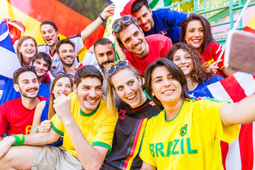 Football supporter taking a selfie at stadium