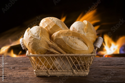 Basket of "French bread", traditional Brazilian bread with fire background.