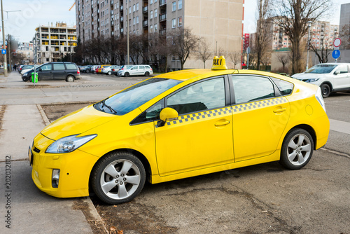 Yellow taxi on parking in a residential area