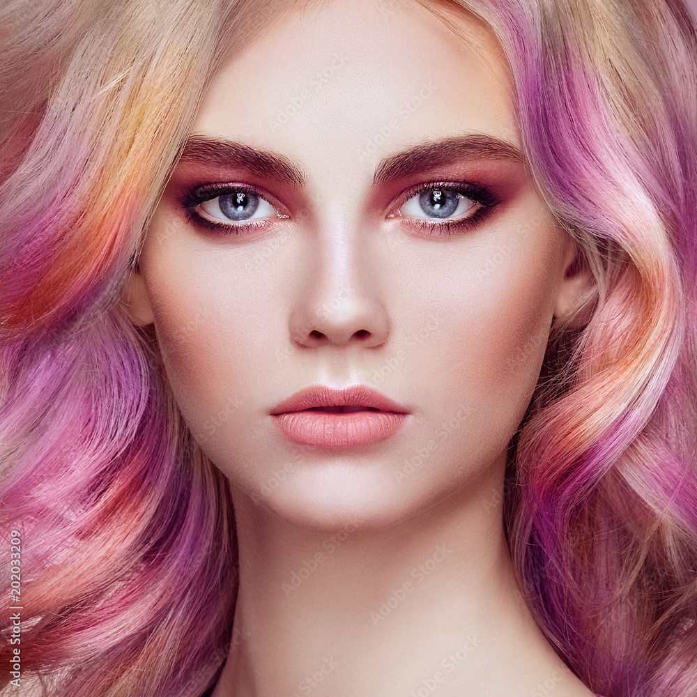 Fototapeta premium Beauty Fashion Model Girl with Colorful Dyed Hair. Girl with perfect Makeup and Hairstyle. Model with perfect Healthy Dyed Hair. Rainbow Hairstyles