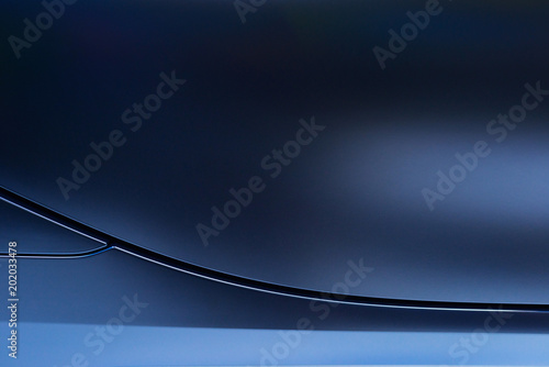 Abstract of blue car door with lines and light reflection