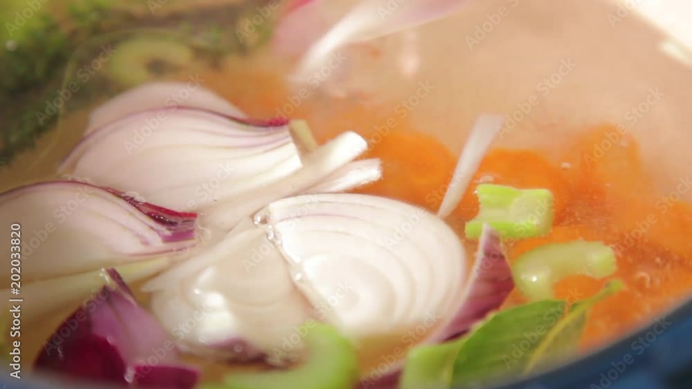 A close up shot of onions being blanched to hot water. A close up shot of onions being blanched to hot water.