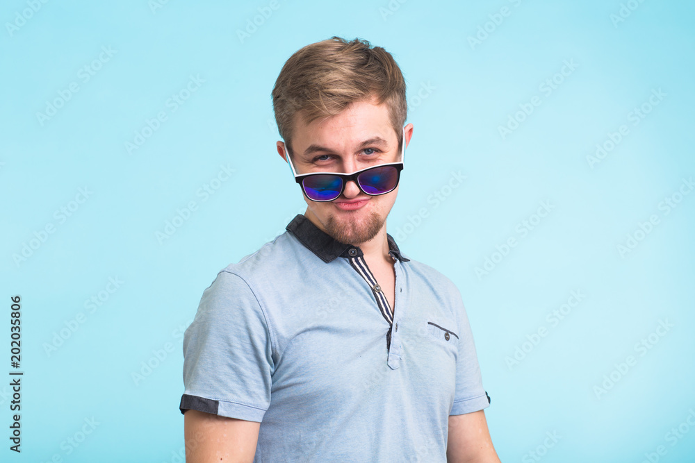 Portrait of a handsome man dressed in polo t-shirt on blue background Portrait of a handsome man dressed in polo t-shirt on blue background