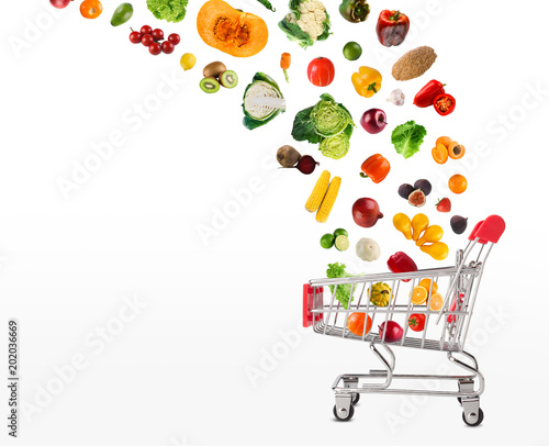 Collage of shopping cart with vegetables and fruits isolated on 