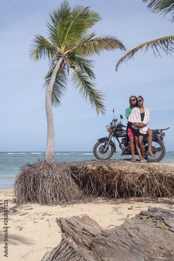 Fototapeta premium A man and a girl are traveling by motorcycle. Beach, sea