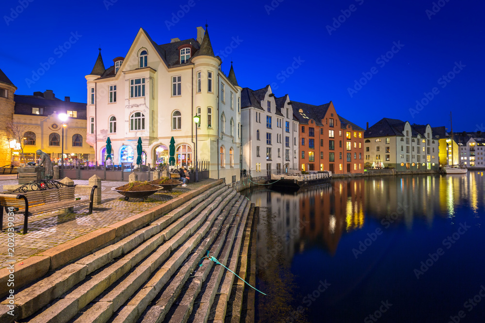 Architecture of Alesund town at night in Norway